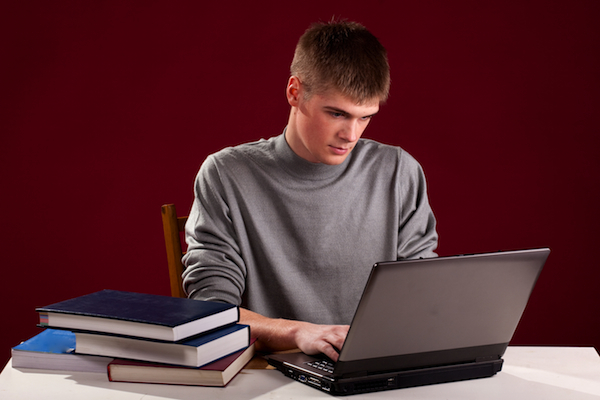 A young teen uses the ZAPS College Vocabulary Challenge app on his smartphone.